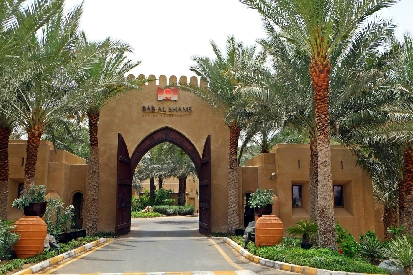 Entrance lined with date palms